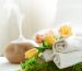 Spa composition with the aroma of a modern oil diffuser with body care products . Twisted white towels, spring greens and flowers. Spa concept for body and health care .